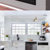 A kitchen cabinet installation featuring a modern aluminum alloy rectangular ventilation grille above the cabinets.