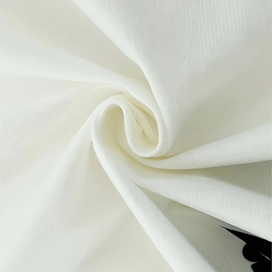 A close-up of a white polyester tapestry fabric folded into a swirl.