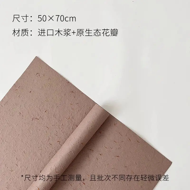 A sheet of brown decorative packaging paper, rolled up, used for flower petal decoration.