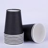 A stack of black and white disposable tableware cups.