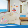 A set of birthday cruise door magnets featuring a ship, crown, and tropical elements decorating a white wall.