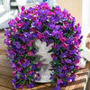 A vibrant purple and magenta faux bougainvillea vine garland displayed on a white pedestal.