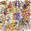 A collection of small bobblehead dog and cat mini figures in various colors and styles.