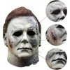 A realistic horror mask resembling Michael Myers, featuring pale skin and facial scarring.