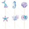 A set of mermaid tail, seashell, and sea star cake toppers in purple and blue glitter.