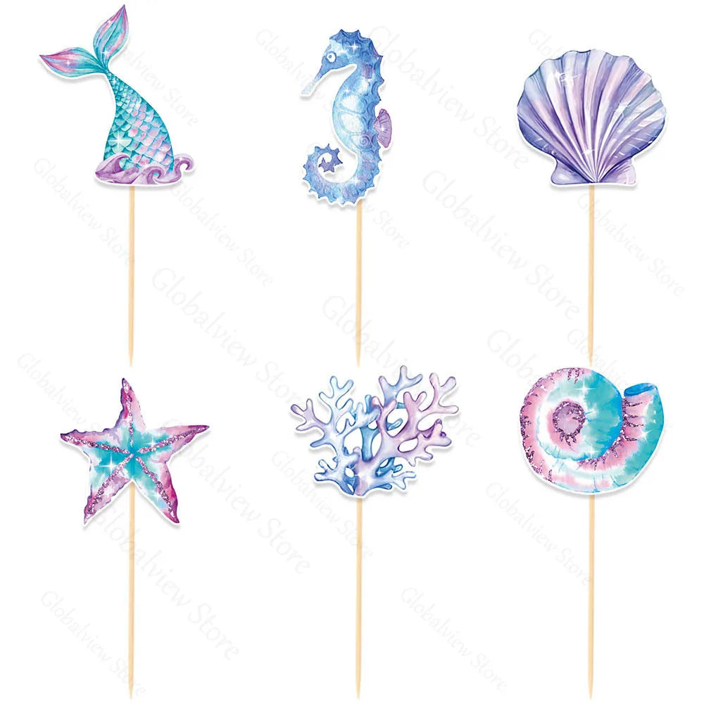 A set of mermaid tail, seashell, and sea star cake toppers in purple and blue glitter.