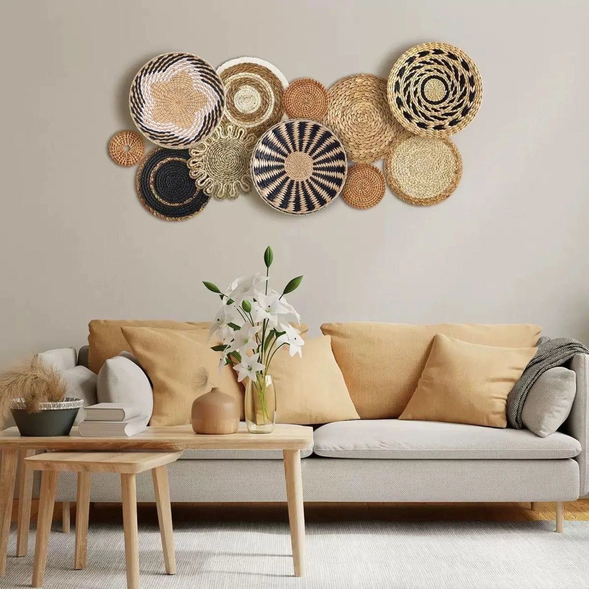 A decorative wall hanging made of various woven straw and natural fiber tassels in earthy tones.
