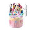 A round pink birthday cake decorated with colorful floral drips and anime girl character toppers.