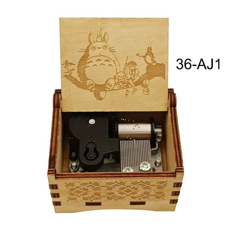A wooden music box featuring an anime character design on the lid and a mechanical mechanism inside.