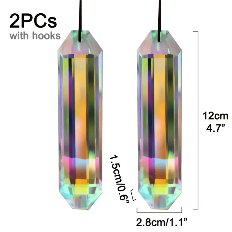A pair of iridescent crystal pendants with hooks, featuring rainbow colors and a prismatic finish.