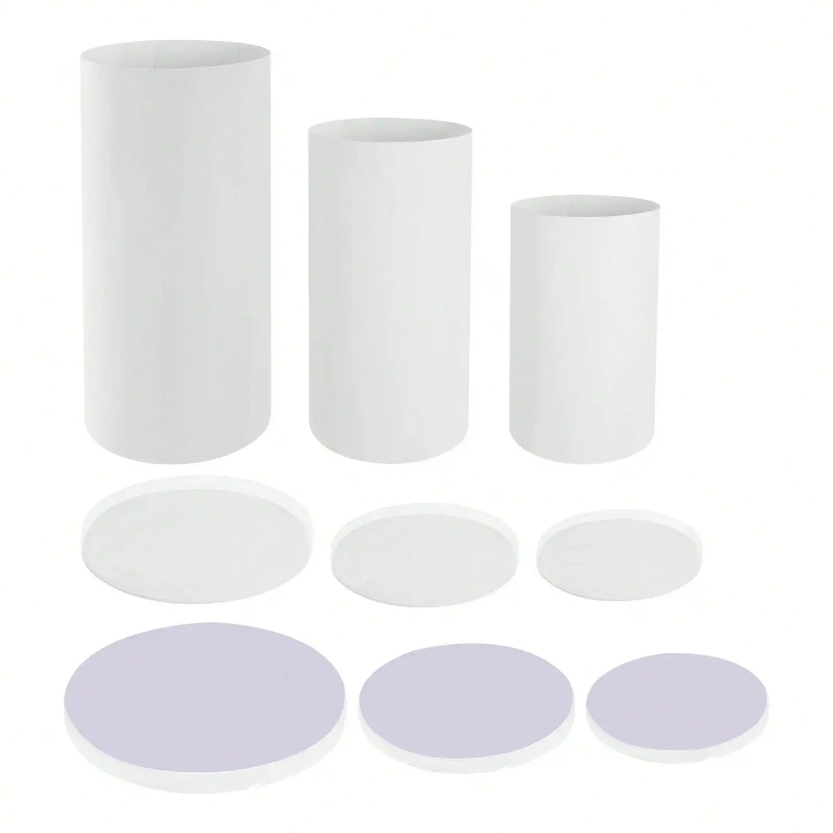 A set of three white cylinder pedestal display stands, including three tall cylinders and four round discs.