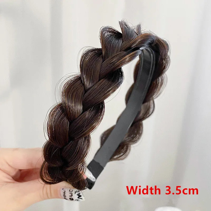 A hand holds a black braided hair band featuring dark brown hair, used for fashion or party accessories.
