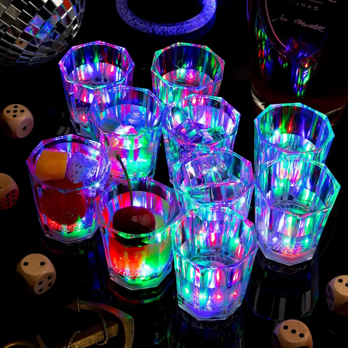 A collection of shot glasses filled with colorful liquid and illuminated by internal LED lights for parties