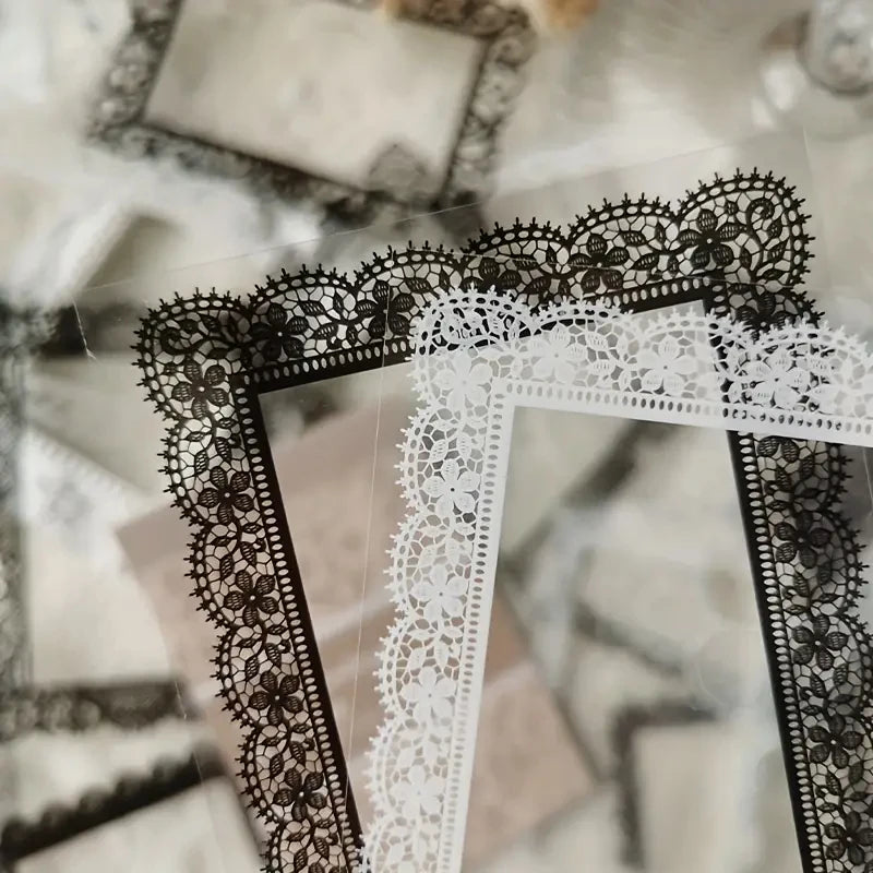 A close-up of black and white lace stickers, including a black and white floral pattern and a white lace border.