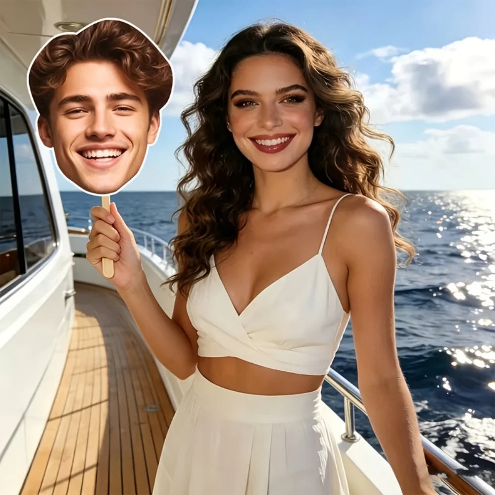 A smiling woman with long wavy hair wearing a white outfit stands on a boat deck with the ocean in the background.