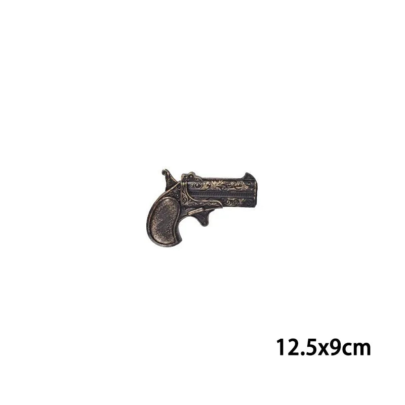 A bronze-colored classic pirate pistol costume prop.