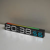 A black LED digital alarm clock displaying 20:38 and the day of the week, resting on a white surface.