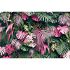 A dense backdrop of various tropical jungle leaves in shades of green and pink for photography.