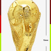 Gold-colored figurine of the FIFA 2026 World Cup Trophy, featuring a detailed depiction of the trophy.