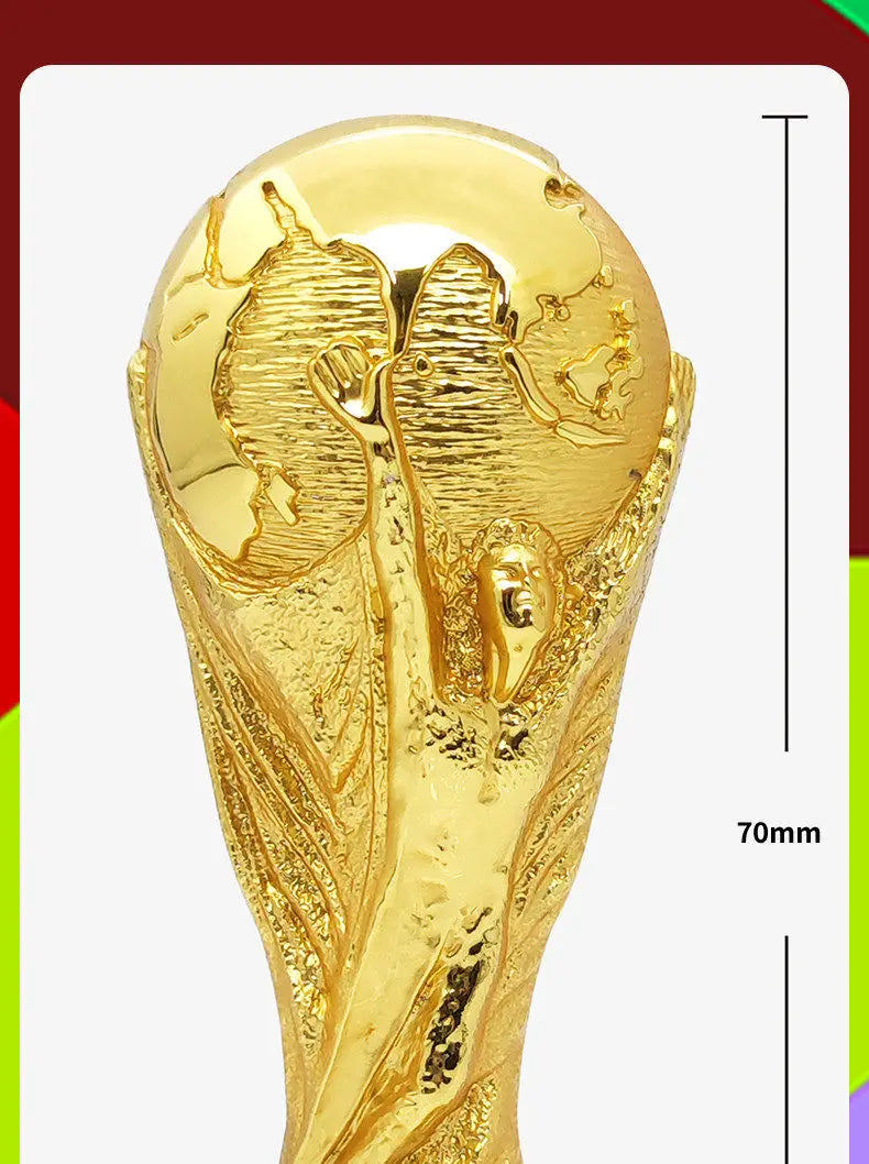 Gold-colored figurine of the FIFA 2026 World Cup Trophy, featuring a detailed depiction of the trophy.