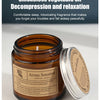 A dark amber jar of Aroma Sensation scented candle with a silver lid, set against a light background.