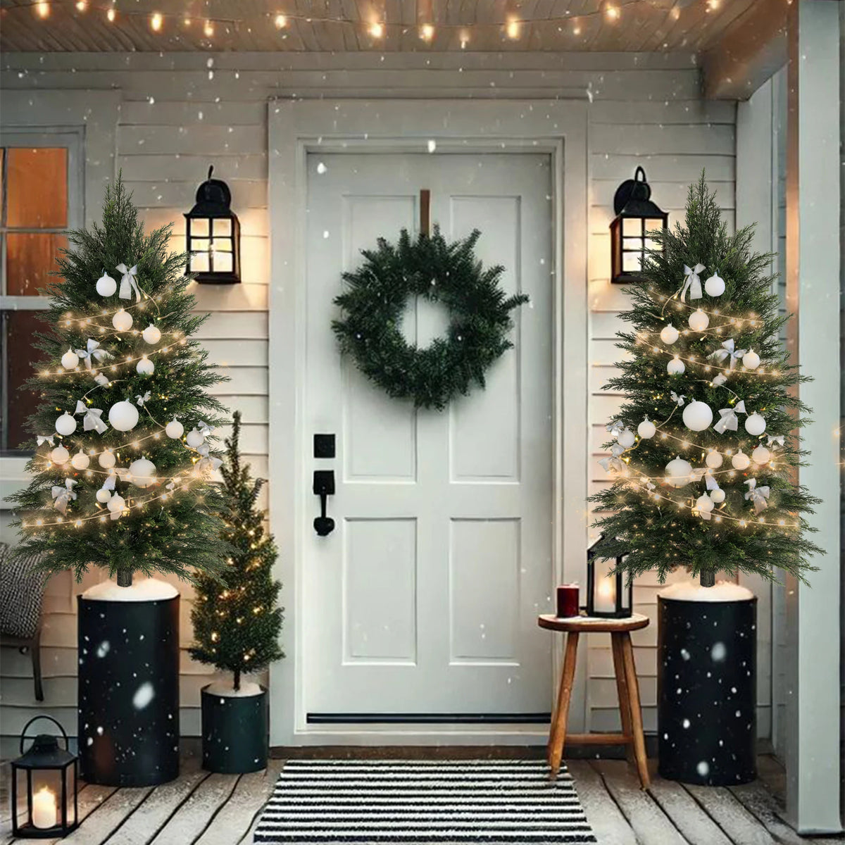 An artificial cedar topiary tree decorated with white lights and ornaments stands next to a white door.