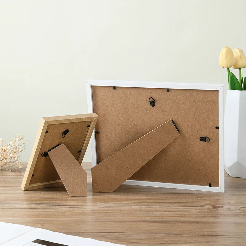A set of wooden photo frames with a cork backing displayed on a wooden surface.