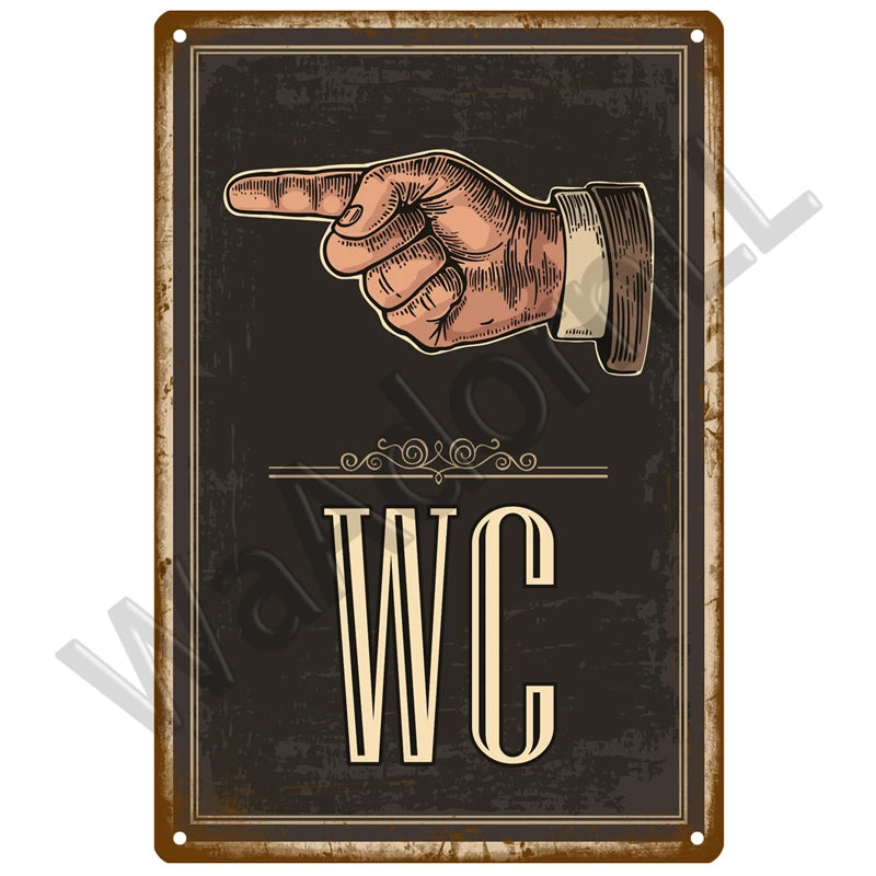 A vintage metal sign featuring a hand pointing and the letters WC on a dark background.