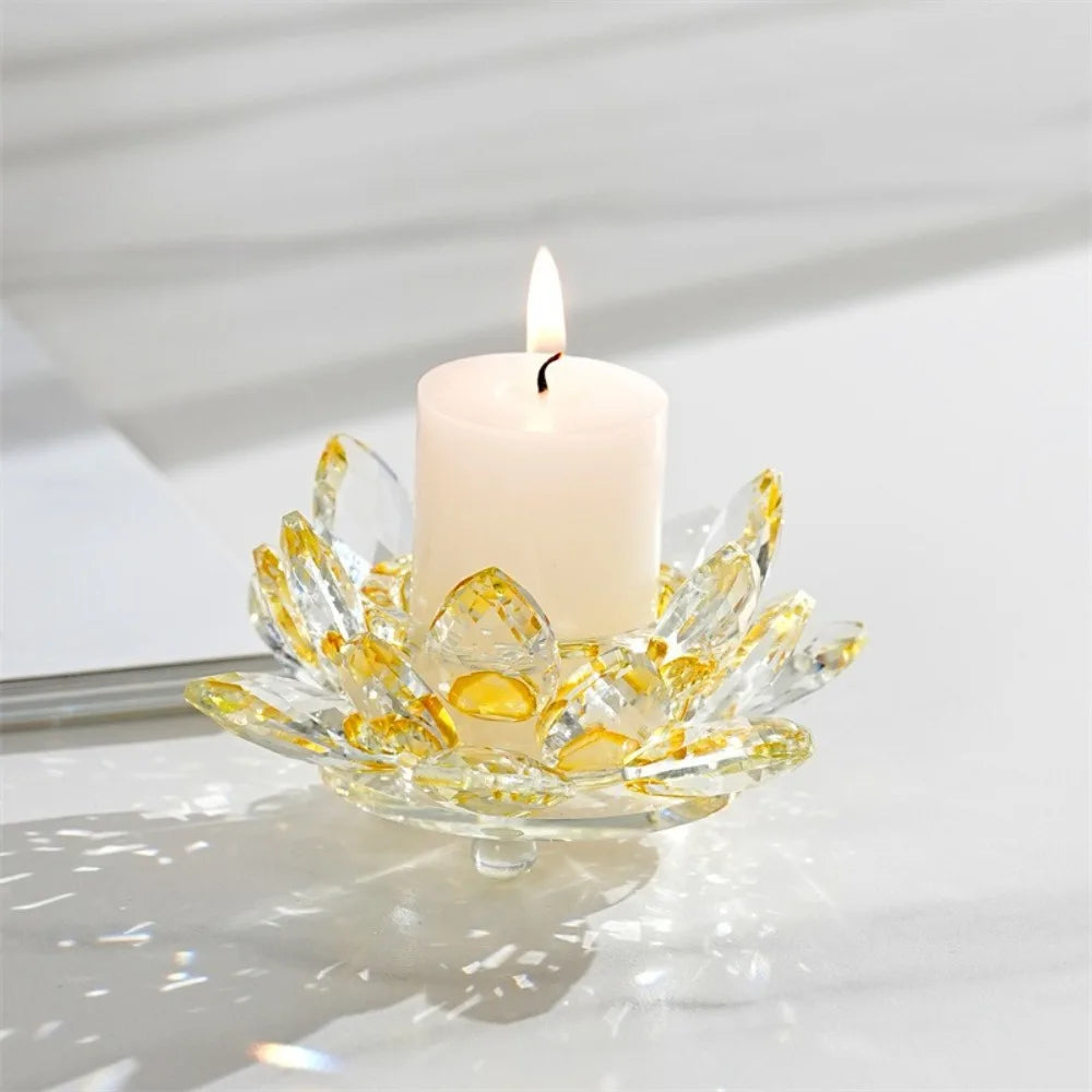A clear crystal lotus candle holder with a white tealight candle is displayed on a light surface.