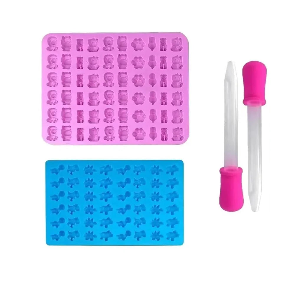A silicone candy mold kit with pink and blue molds and droppers for DIY chocolates and jellies