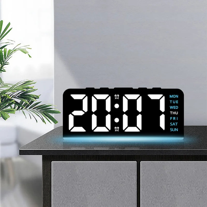A black digital alarm clock displaying 20:07 with blue light, resting on a dark wooden surface.