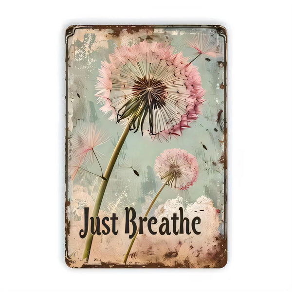 A vintage metal wall sign featuring pink and white dandelion seed heads against a muted teal background with the text Just Br