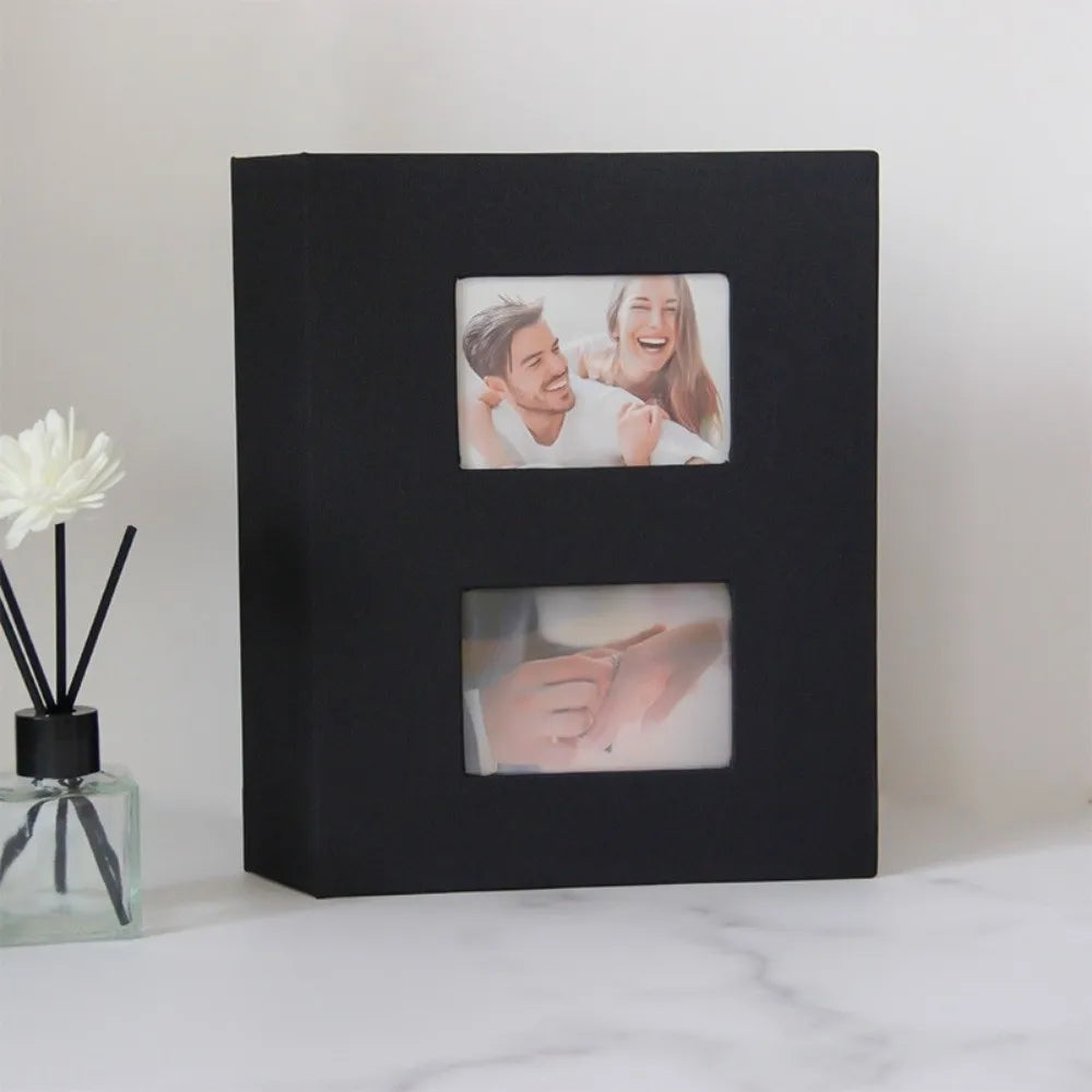 A black photo album with two square compartments displaying candid photos of a couple.