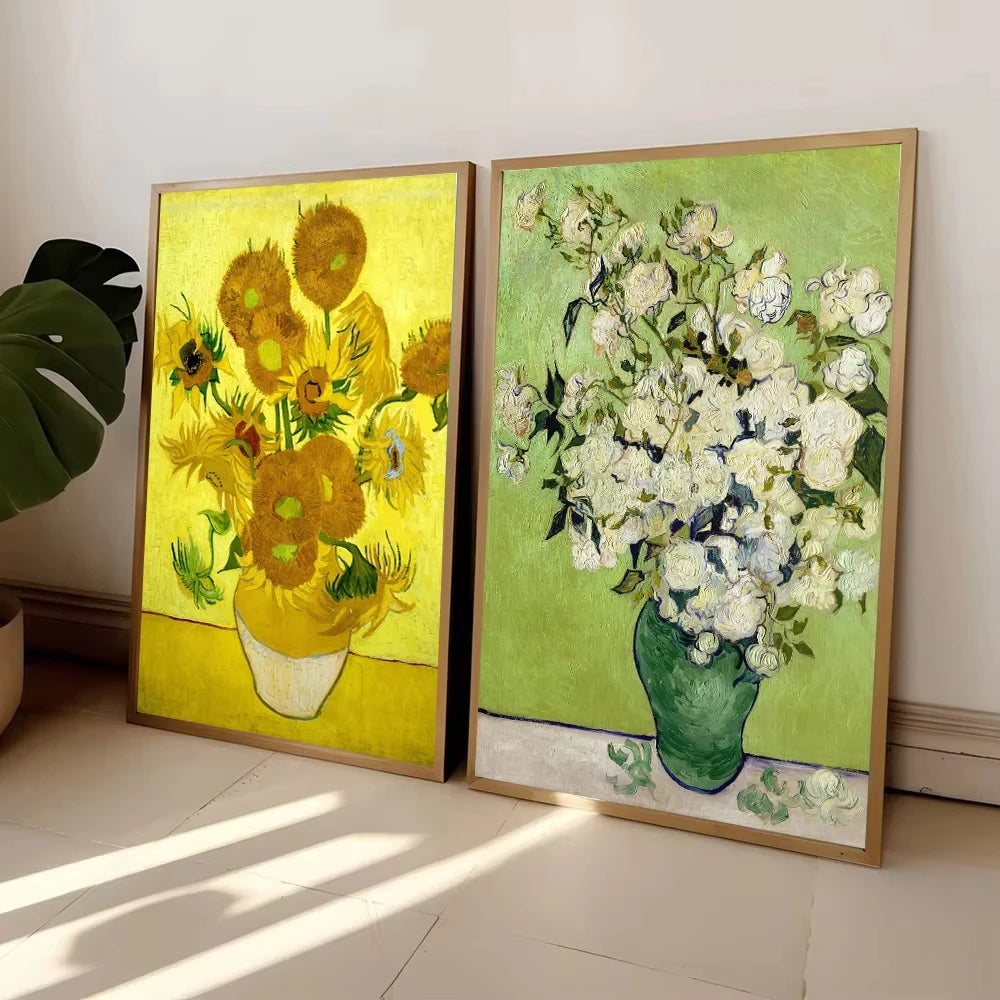 A pair of framed paintings featuring yellow sunflowers and a bouquet of white flowers in green vases.