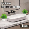 A set of four mini artificial bonsai plants in white pots displayed for home bathroom decor.