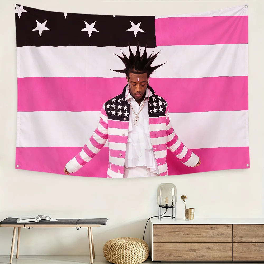 A person wearing a striped jacket stands in front of an American flag banner.