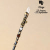 A natural clear quartz zodiac crystal wand featuring gold accents and a star charm.