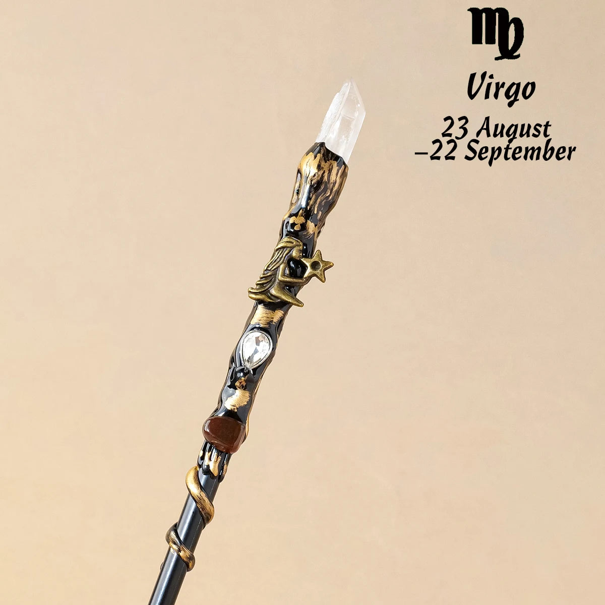 A natural clear quartz zodiac crystal wand featuring gold accents and a star charm.