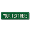 A rectangular green metal street sign with the text YOUR TEXT HERE.