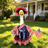 A white goose costume with a red and blue patriotic hat and ruffled fabric, set for the 4th of July.