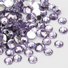 A pile of round flatback resin rhinestones in various shades of purple and silver.
