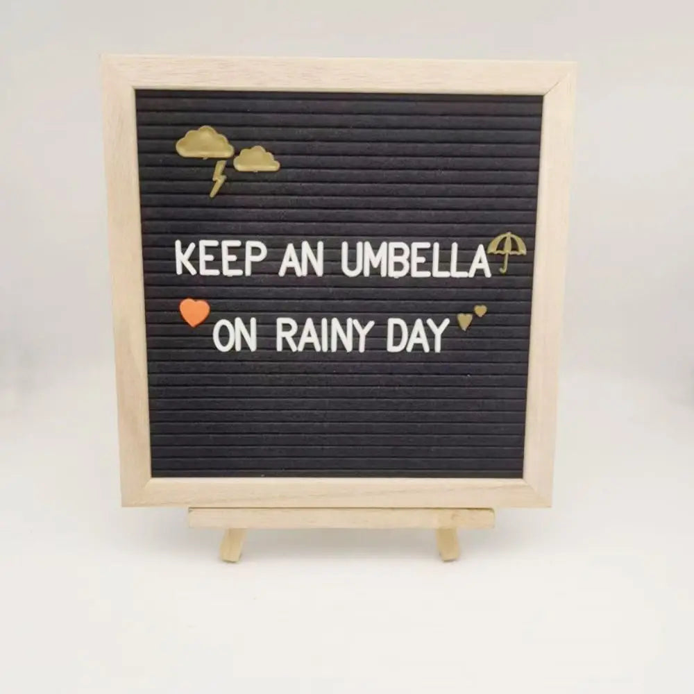 A wooden message board with a black chalkboard surface featuring text and lightning bolt and umbrella icons.
