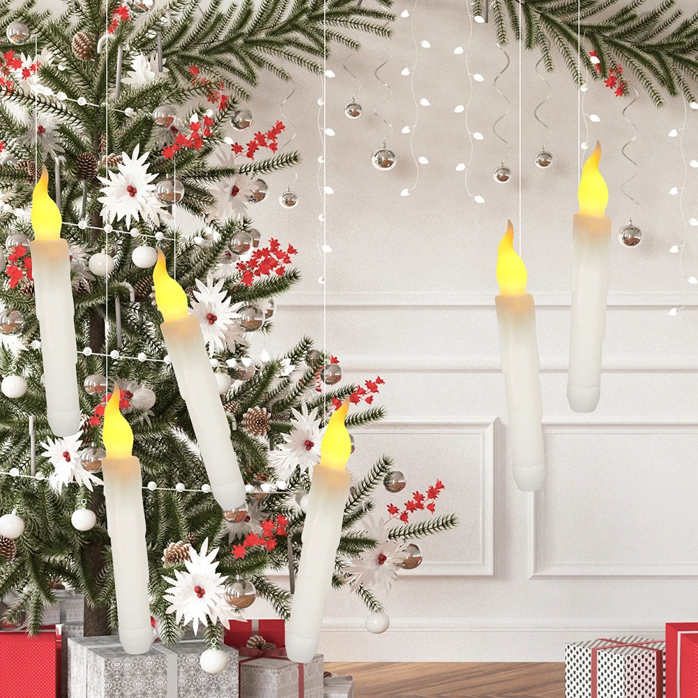 Flameless LED taper candles in white are displayed hanging on a Christmas tree branch against a white wall.