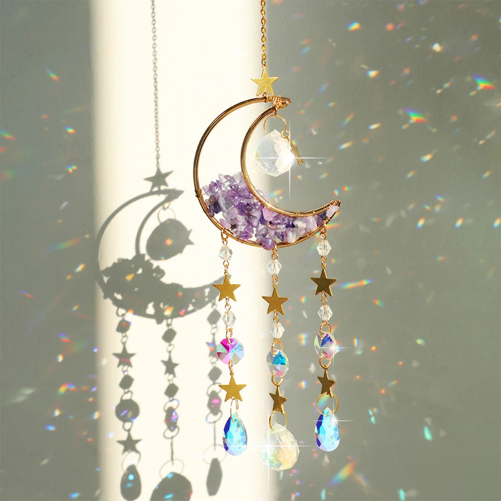 A hanging moon-shaped crystal suncatcher featuring a purple amethyst crescent and sparkling prism elements.