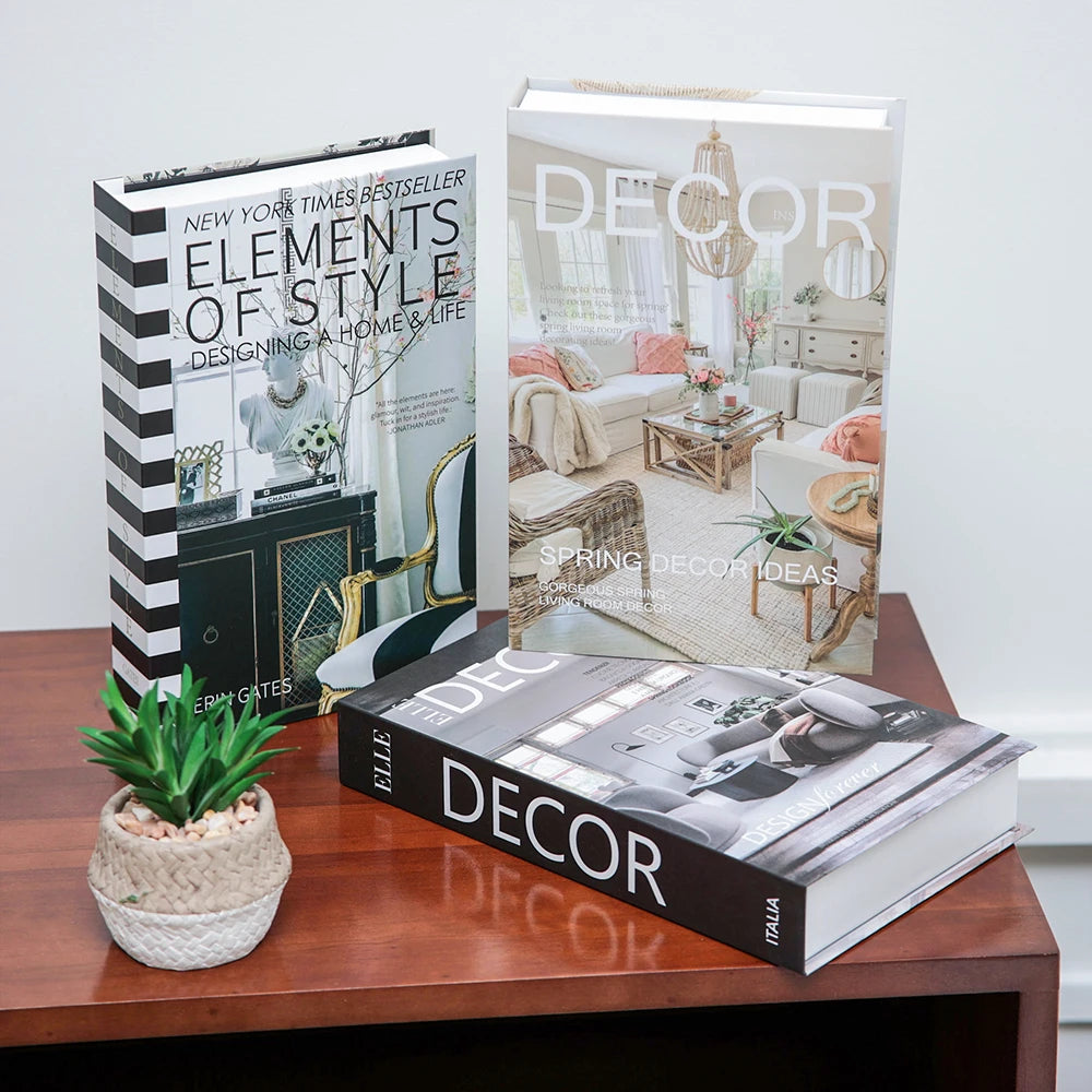 A set of three books featuring interior design and decor ideas displayed on a wooden table.