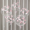 A set of clear latex balloons decorated with pink ribbon bows, displayed against a light gray curtain background.