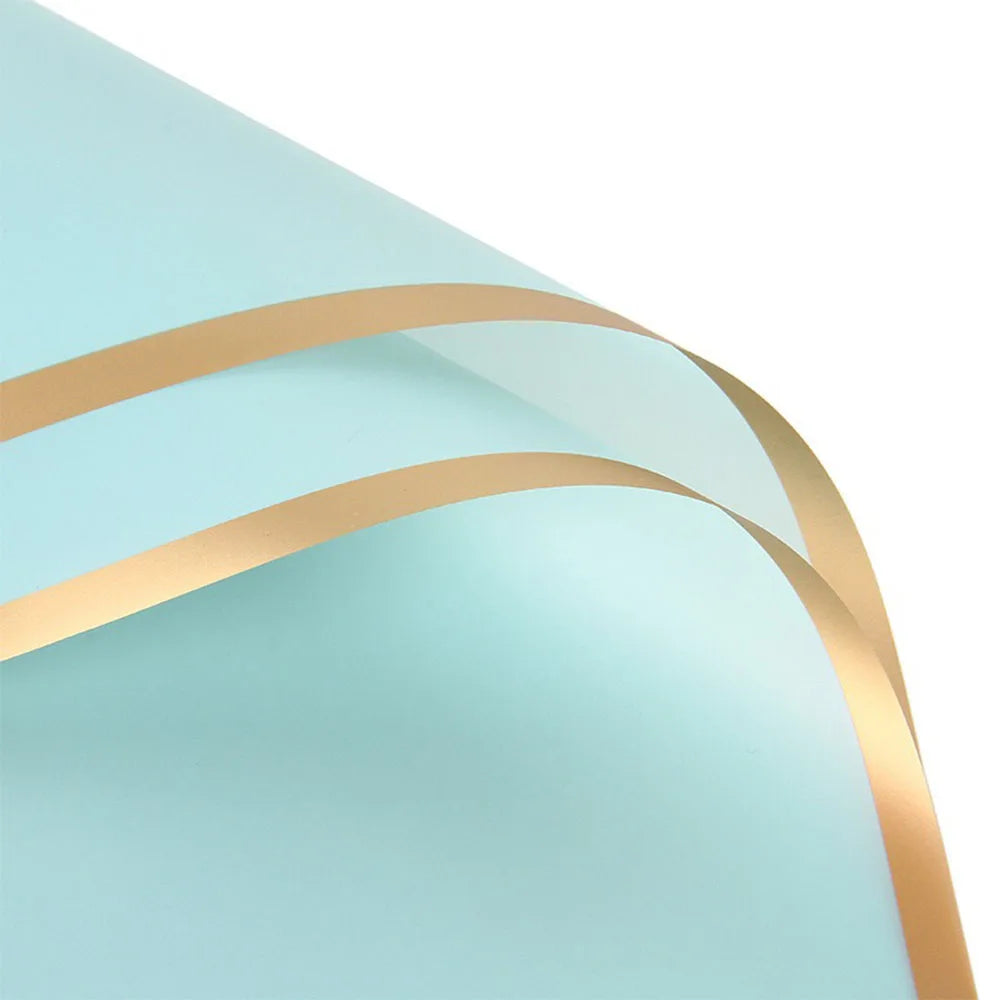 Light blue floral wrapping paper with gold edges shown in a curved, overlapping display.