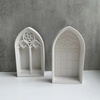 White silicone molds shaped like Gothic church windows for resin and plaster crafting