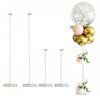A set of silver acrylic balloon stands with gold and pink balloons.