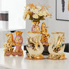 Gold ceramic swan vase for tabletop decor with pink and white floral accents